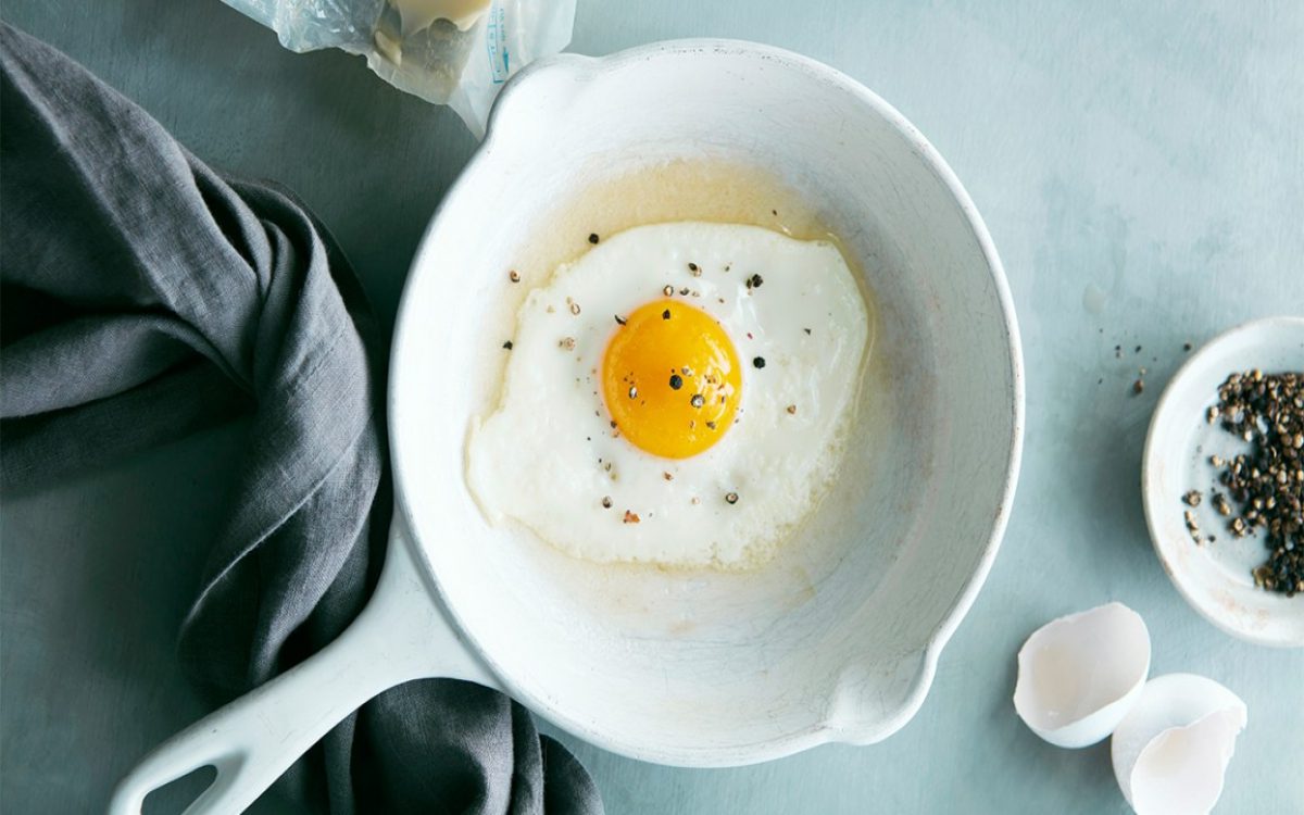 fried egg in a pan with black pepper