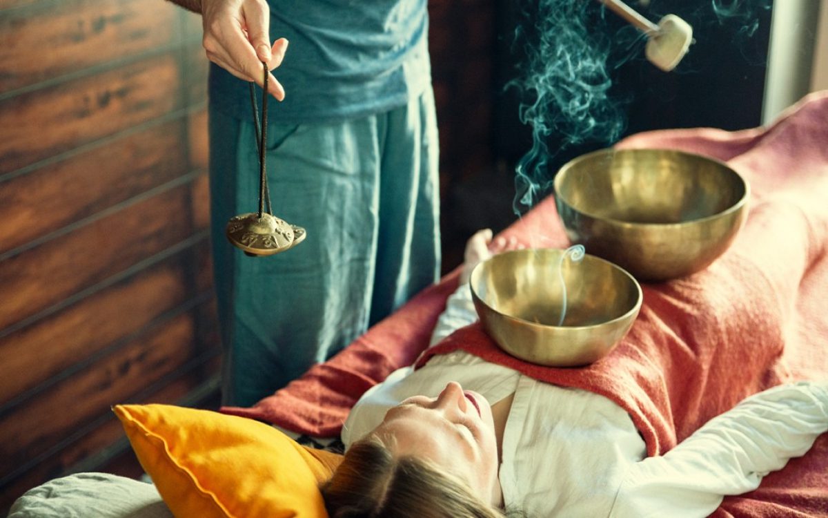 woman receiving singing bowl therapy